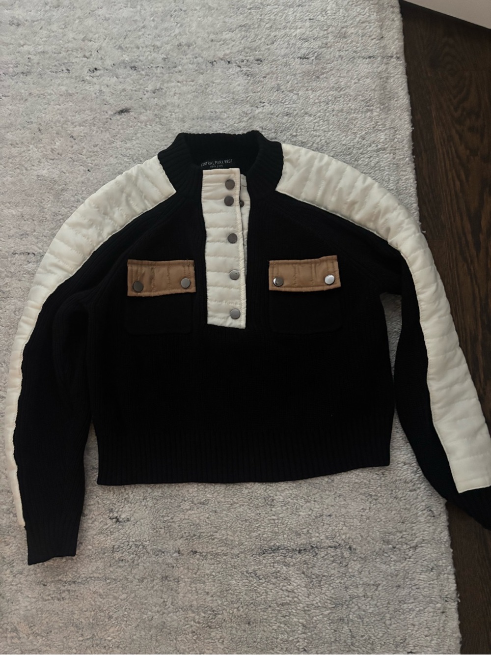 Central Park West Black Sweater with Cream Sleeves and Tan Pocket Flaps